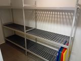 a rack with several shelves in the corner of a room