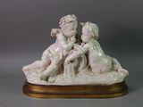 a figurine of a boy and a girl sitting on a bench