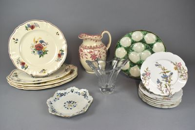 a lot of plates and cups and vases on the table