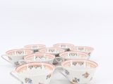 six cups and saucers with floral designs on them on a white surface