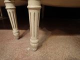 a close up of the legs of a white table