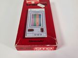 an old nintendo game console in a red box on a white surface