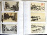 an open book with pictures of a city in it on a table