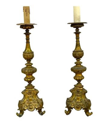pair of antique brass candlesticks with candles in the form of lions