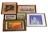 a lot of framed art on the wall