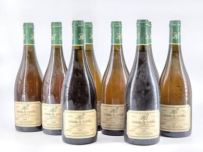 six bottles of wine sitting next to each other on a white surface