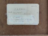 a picture of a picture of a name tag on a piece of wood