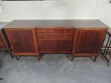 an image of a wooden sideboard with two stools