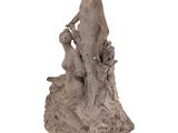 statue of a man sitting on a rock with a bird in his hand