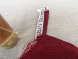 a close up of a bra with a glass of beer next to it