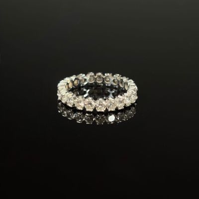 a close up of a diamond ring on a black surface