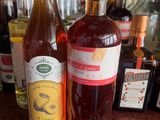 a bottle of wine and a bottle of liquor on a bar