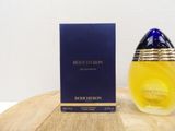 the bottle of the perfume is next to the box on the table