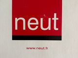 a white box with a red and black logo on it