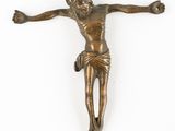 an antique bronze crucifix of jesus on a white background