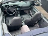 a car that is parked on the street with its top down