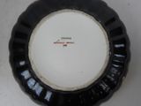 a black and white plate with a red writing on it