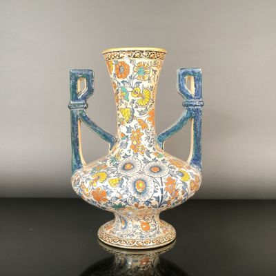 a vase that is sitting on a table with a black surface