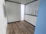 an image of a room with a blue door and white walls