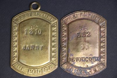 two gold medals with the names of two people on them