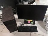 a desktop computer and keyboard on the floor next to a monitor