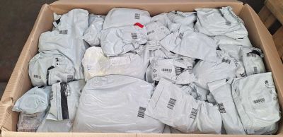 a cardboard box full of white shirts in it