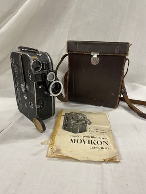 deux vieux appareils photo et un livre posés sur une table