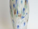 a blue and white vase sitting on a white surface