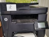 a printer sitting on top of a table with a charger attached to it