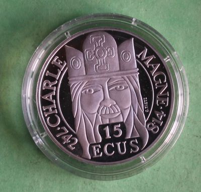 a close up of a coin on a green surface