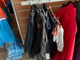 many clothes hanging on a rack in a room