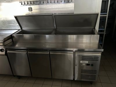 a stainless steel counter with two sinks in the kitchen