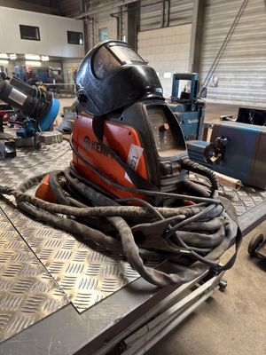 a welding helmet sitting on top of a table in a factory