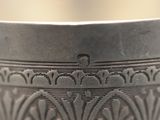 a silver cup that has a cross on it