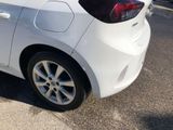 a white car that is parked on the side of the road