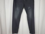 a pair of jeans hanging on a curtain in front of a white curtain