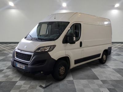 the white van is parked on a checkered floor in a room
