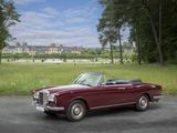 a red convertible car parked on the side of the road