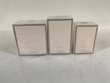 three empty boxes of perfume sitting on a white surface