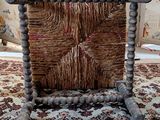 a picture of a chair made out of wood and wicker