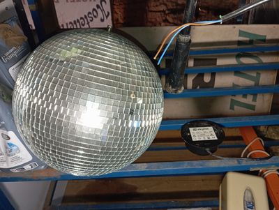 a disco ball hanging from a rack in a room