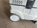 a white machine that is sitting on a tiled floor