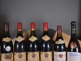 several bottles of wine are lined up in a row on a table