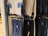a rack of sports clothing in a store with a baseball bat