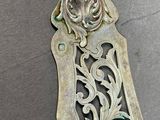 a silver spoon with a design on it on a table