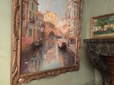a painting on the wall above a fireplace in a room