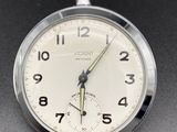 a close up of a pocket watch on a table