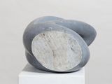 a sculpture of a rock on top of a white box