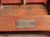 an old wooden sewing machine with a sign on it