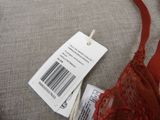 a red bra with a price tag attached to it